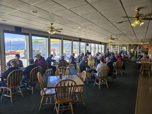 a group of people sitting at tables in a restaurant at Talbot Arm Motel in Destruction Bay