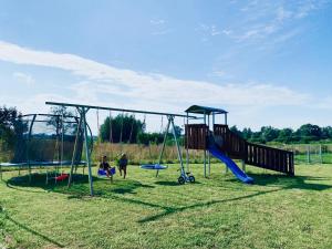 a group of people playing on a playground at Dom Wczasowy u Marci in Tymień