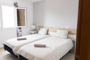 a bedroom with two beds and a mirror and a window at Tranquil 2BR :Private Pool & Ocean Views in Callao Salvaje +68 photos