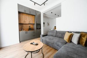 a living room with a couch and a table at Port View Suites in Volos