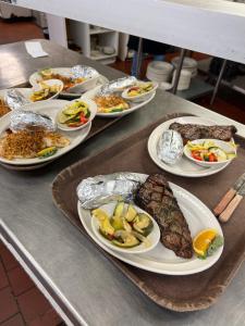 a table with many plates of food on it at Town & Country Inn & Resort in Gorham