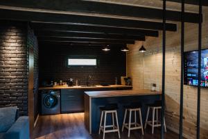 a kitchen with two bar stools and a counter at Kazbegi Hills Cottages in Kazbegi