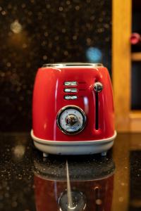 a red toaster sitting on top of a counter at Old Winery Stonehouse in Peletá