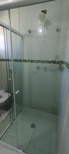 a shower with a glass door in a bathroom at Casa na Montanha in Campos do Jordão