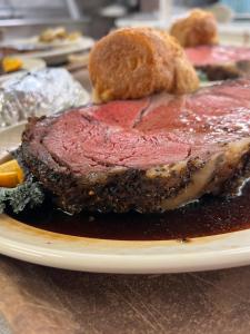 a plate with a piece of meat on a table at Town & Country Inn & Resort in Gorham