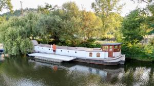 a boat tied up to a dock in the water at Prague on Boat, Privat Pier, Free Parking in Prague