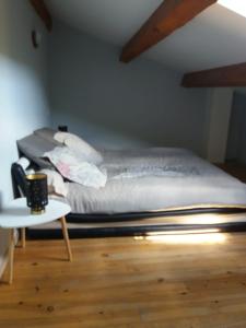 a bed in a room with a table and a bed at Maison de village dans Languedoc-Roussillon in Vergèze +1 photo
