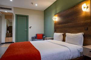 A bed or beds in a room at Manzil Hotel