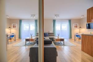 a living room with a couch and a table at Studio 51 Baltic Park, 280m do Plaży, Duży balkon in Pogorzelica +18 photos