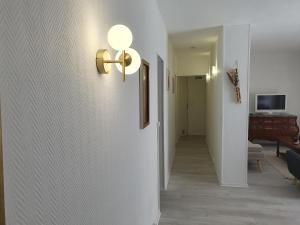 a hallway with a light switch on a wall at Le lilas d orly in Orly