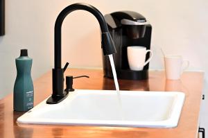 a kitchen sink with a faucet with water coming out at Dos Hermanas Casita 4 Downtown Courtyard Patio in Santa Fe
