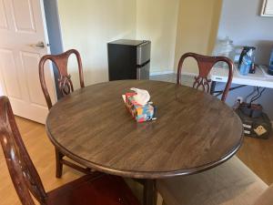 a wooden table with chairs and a box on it at Big band home in Burnaby
