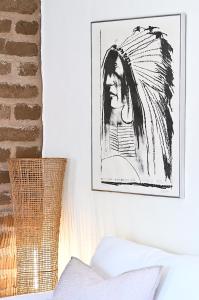 a picture of a woman on a wall at Dos Hermanas Casita 2 Downtown Courtyard in Santa Fe