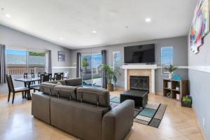 a living room with a couch and a table and a television at Oasis tranquil home Retreat Private Pool, Spa, and BBQ in Desert Hot Springs