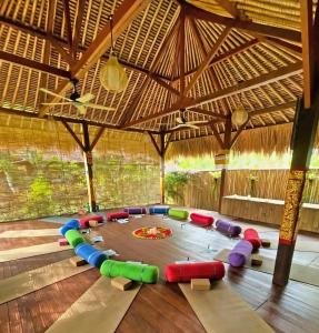 a large room with a play room with a table at Island Garden Huts Lembongan in Nusa Lembongan