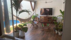 a living room with potted plants and a hammock at Casa Intensamente in Jesús María