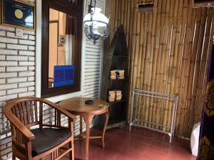 un tavolo e una sedia in una stanza con una parete di 1BD guest house in family compound ubud3, 15 minute walk to yoga barn ad Ubud