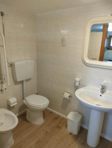 a bathroom with a toilet and a sink at Casa Costantino in Alcamo