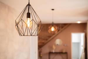 aendant light hanging from a ceiling in a room at Cozy Up Spain in Valencia