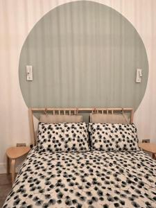 a bedroom with a bed with a large headboard at Urban Oasis 2 bed apartment in Manchester +4 photos