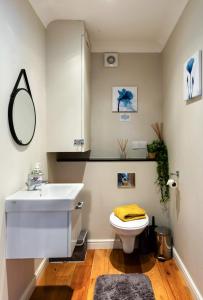 a white bathroom with a sink and a toilet at Teta's House! in Oxford +38 photos