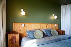 a bedroom with a large bed with blue pillows at Oceanview Suite in Hapuku +41 photos