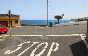 a stop sign on a street next to the ocean at Cozy Apartment In Garachico With Wifi in Garachico +14 photos