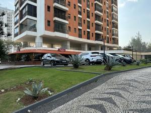 a parking lot with cars parked in front of a building at Desativado in Rio de Janeiro