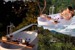 a woman sitting in a bath tub with a glass of wine at One villa coffee farm stay 1 in Ban Huai Khai