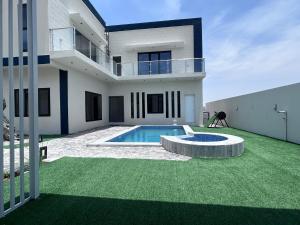 a house with a swimming pool in the yard at Najm Chalet in Ḩayl Yaman