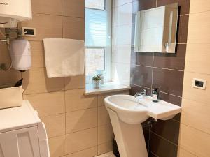 a bathroom with a sink and a mirror at Emica's holiday home in Koper