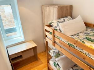 a bedroom with a bunk bed and a table at Emica's holiday home in Koper