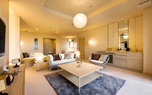 a living room with a couch and a table at Katakura Silk Hotel in Suwa