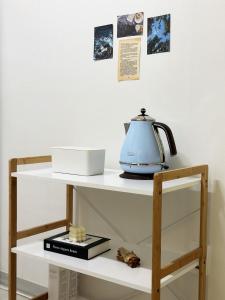 a shelf with a teapot on top of it at Jamsil Seokchon-dong #Lotteworld #Seokchonlake #Lottetower #KSPO DOME #stadium in Seoul