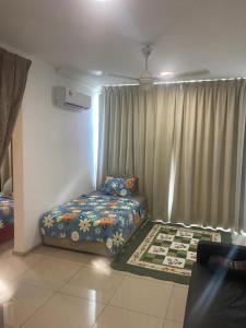 a bedroom with a bed and a window with curtains at Vista Alam Roomstay Homestay in Shah Alam