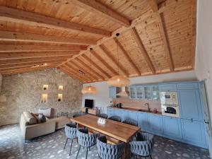 a kitchen and living room with a wooden ceiling at House Yara Dalmatia in Kruševo