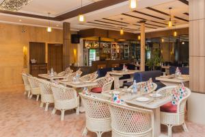 a restaurant with tables and chairs and a bar at Hotel Mirage Regency in Kathmandu