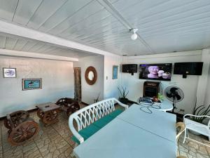 a living room with a couch and a tv at CozyVilla at Villa Astudillo Pansol Private Hotspring Resort in Calamba