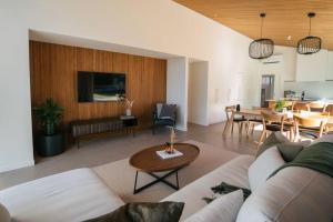 a living room with a couch and a table at Abodo Alpine Eco Villa Spa in Cardrona