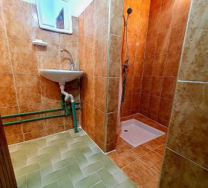 a bathroom with a sink and a shower at Riad Taourirte in Tinerhir +45 photos