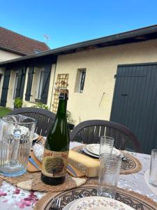 a bottle of wine sitting on top of a table at La Balade in Saint-Aubin
