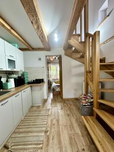 a kitchen with white cabinets and wooden floors at Agroturystyka u Beci in Sorkwity