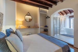 a bedroom with a bed and a tub in a room at La Tartana Hotel Boutique in La Herradura