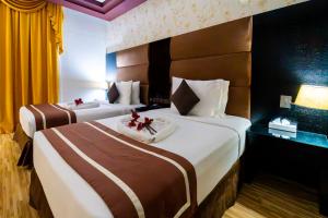Postel nebo postele na pokoji v ubytování Mangrove Hotel
