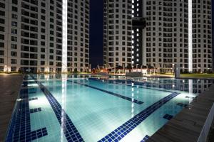 a large swimming pool with tall buildings in the background at KSL Residences 2 Premier Suites Johor Bahru in Johor Bahru