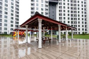 a pavilion with benches and tables in a park at KSL Residences 2 Premier Suites Johor Bahru in Johor Bahru