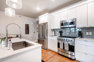 a kitchen with white cabinets and stainless steel appliances at Mayflower Lakeside 1121-103 by Moose Management in Heber City