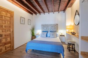 a bedroom with a bed and a wooden ceiling at La Tartana Hotel Boutique in La Herradura