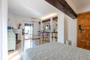a bedroom with a bed and a wooden door at La Tartana Hotel Boutique in La Herradura