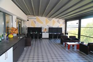 a large room with chairs and tables and windows at Cihan Palas in Ankara